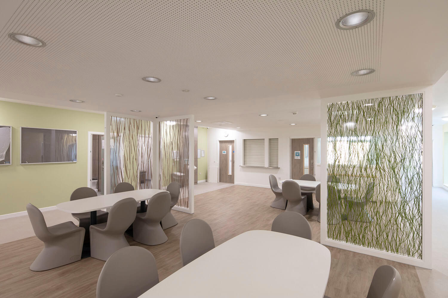 Calm day lounge at Foss Park in muted green with soft seating and daylight